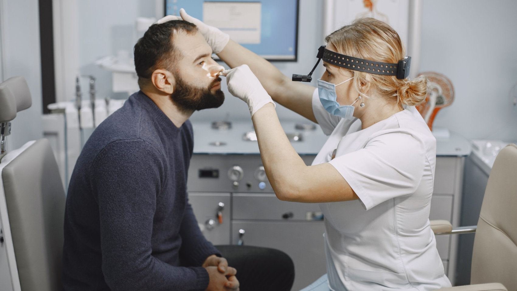 Man patient in the medical office. Doctor in medical mask.