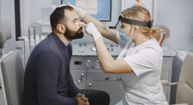 Man patient in the medical office. Doctor in medical mask.